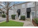 Gray duplex with black awnings, landscaping, and brick walkways at 285 Oxford Ne Pl # 4, Atlanta, GA 30307