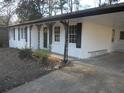 White brick ranch house with black shutters and a covered carport at 545 Oak Valley Dr, Riverdale, GA 30274