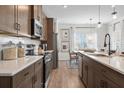 Modern kitchen with dark cabinets, quartz countertops, and stainless steel appliances at 726 Shetland Trl, Cartersville, GA 30121