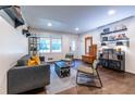 Bright living room with hardwood floors, comfy seating, and built-in shelving at 2849 Crescendo Nw Dr, Atlanta, GA 30318