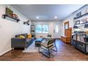 Living room with hardwood floors, gray sofa and green accent chair at 2849 Crescendo Nw Dr, Atlanta, GA 30318