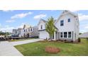 Traditional two-story home featuring a manicured lawn and a concrete driveway, in a developing community at 123 Cherry Glen Way, Euharlee, GA 30145