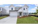 Charming two-story home featuring a classic color scheme, well-manicured lawn and a two car garage at 123 Cherry Glen Way, Euharlee, GA 30145