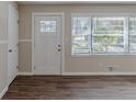 Bright entryway with hardwood floors, white door, and large windows at 2599 Browns Mill Se Rd, Atlanta, GA 30354