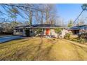 Brick ranch home with a red front door and spacious yard at 2599 Browns Mill Se Rd, Atlanta, GA 30354