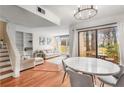 Open concept living and dining area with hardwood floors and access to backyard at 4882 Twin Lakes Trl, Atlanta, GA 30360