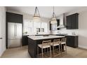 Modern kitchen with dark cabinetry, stainless steel appliances, and an island at 1341 Grannysmith Trce # 45, Brookhaven, GA 30319
