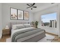 Spacious bedroom with large window and city views; virtually staged at 860 Peachtree Ne St # 1617, Atlanta, GA 30308