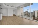 Open living area with hardwood floors and access to a balcony at 860 Peachtree Ne St # 1617, Atlanta, GA 30308