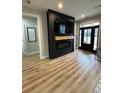 Living room with a modern fireplace and light wood-look flooring at 1217 Eagles Nest Cir, Carrollton, GA 30116