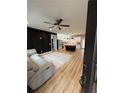 Open living space with light flooring, a gray sectional sofa, and an island kitchen at 1217 Eagles Nest Cir, Carrollton, GA 30116