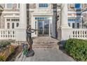 Elegant entryway with double doors, classic columns, and bronze statues at 3352 Forest Vista Dr, Dacula, GA 30019