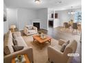Virtually staged living room with beige sofas and a fireplace at 5165 Hanover St, Atlanta, GA 30349