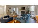 Living room with hardwood floors, fireplace, and a Christmas tree at 2135 N Forest Trl, Atlanta, GA 30338