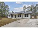 Charming one-story house featuring a gray roof and spacious yard at 3590 Ashley Woods Dr, Powder Springs, GA 30127