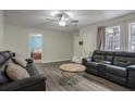 Spacious living room with leather sofas and hardwood floors at 3590 Ashley Woods Dr, Powder Springs, GA 30127