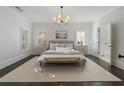 Serene primary bedroom with neutral tones, plantation shutters, and ensuite bathroom access at 6725 Cross Gate St, Cumming, GA 30040
