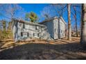 Gray two-story house with large windows and mature trees at 2668 Woodfen Dr, Ellenwood, GA 30294