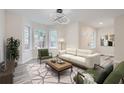 Virtually staged living room featuring a white sofa and wood coffee table at 253 Fletcher Sw St, Atlanta, GA 30315