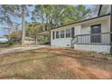 Brick home with covered porch and landscaping at 4809 Hemlock Sw Dr, Austell, GA 30106