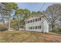 White brick home with mature trees and landscaping at 4809 Hemlock Sw Dr, Austell, GA 30106