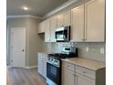 Modern kitchen with stainless steel appliances and light beige cabinets at 3851 Shelleydale Dr, Powder Springs, GA 30127