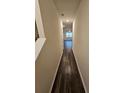 Long hallway with dark wood floors leading to living area at 449 Broder Farms Dr, Stockbridge, GA 30281