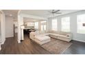 Spacious living room with L-shaped sectional and hardwood floors at 301 Rexmere Rd, Mcdonough, GA 30252