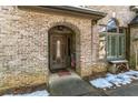 Inviting front entrance with an arched entryway and wooden door at 570 Pleasant Grove Rd, Mcdonough, GA 30252