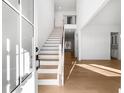 Bright and airy entryway with a staircase, hardwood floors and large windows at 205 Carrington Pt, Canton, GA 30115