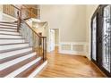 Elegant entryway with hardwood floors and grand staircase at 206 Woodridge Pkwy, Canton, GA 30115