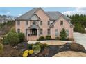 Attractive two-story brick home with a well-manicured lawn and inviting facade at 206 Woodridge Pkwy, Canton, GA 30115