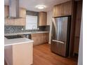 Modern kitchen with stainless steel appliances and light wood cabinets at 2614 Lilac Dr, Morrow, GA 30260