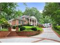 Brick home with circular driveway and manicured lawn at 1120 Heards Ferry Rd, Sandy Springs, GA 30328