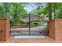 Ornate black gate with brick pillars leading to home at 1120 Heards Ferry Rd, Sandy Springs, GA 30328