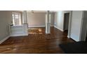Bright and airy living room with hardwood floors, decorative columns, and built-in shelving at 240 Dogwood Dr, Canton, GA 30114