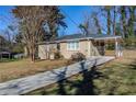Front view of charming ranch house with a long driveway at 2182 Loring Ct, Decatur, GA 30032