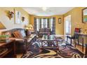 Living room featuring leather sofas, a coffee table, and warm-toned walls at 4450 Millenium View Ct, Snellville, GA 30039