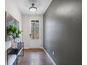 Bright entryway with hardwood floors, console table, and view to backyard at 10122 Windalier Way, Roswell, GA 30076