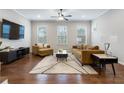 Spacious living room with hardwood floors, comfortable seating, and large TV at 10122 Windalier Way, Roswell, GA 30076