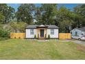 Cute bungalow with a freshly painted exterior and landscaped lawn at 2082 Perkerson Sw Rd, Atlanta, GA 30310