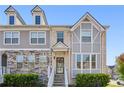Stylish townhome boasts gray siding, stone accents, and a charming front entrance at 5534 Radford Loop, Fairburn, GA 30213