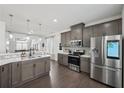 Spacious kitchen with stainless steel appliances, ample counter space, and dark wood flooring at 5534 Radford Loop, Fairburn, GA 30213