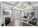 Cozy living room with fireplace, coffered ceiling, and stylish decor, perfect for relaxation at 5534 Radford Loop, Fairburn, GA 30213