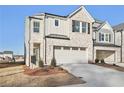 Two-story brick home with a two-car garage and landscaping at 4182 Waratah Way, Mableton, GA 30126