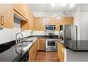 Modern kitchen with stainless steel appliances and hardwood floors at 5300 Peachtree Rd # 3510, Chamblee, GA 30341