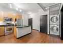 Modern kitchen with island, stainless steel appliances, and hardwood floors at 5300 Peachtree Rd # 3510, Chamblee, GA 30341