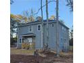 Two-story house with gray siding, wood deck, and large trees at 7190 Buck Creek Dr, Fairburn, GA 30213