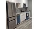 Modern kitchen featuring stainless steel appliances and white cabinets at 7190 Buck Creek Dr, Fairburn, GA 30213