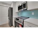 Updated kitchen featuring stainless steel appliances and white shaker cabinets at 1412 Tuxworth Cir, Decatur, GA 30033